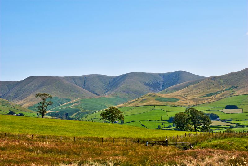Rolling fells above green fields