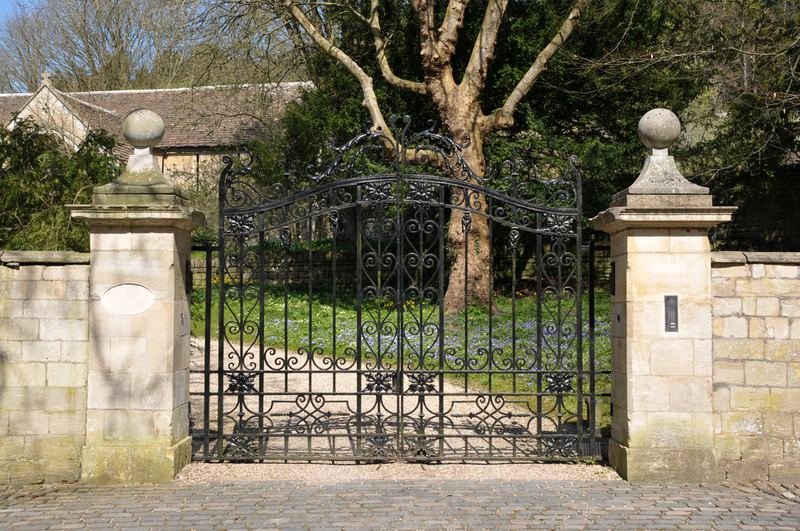 Wrought-iron gates between stone pillars