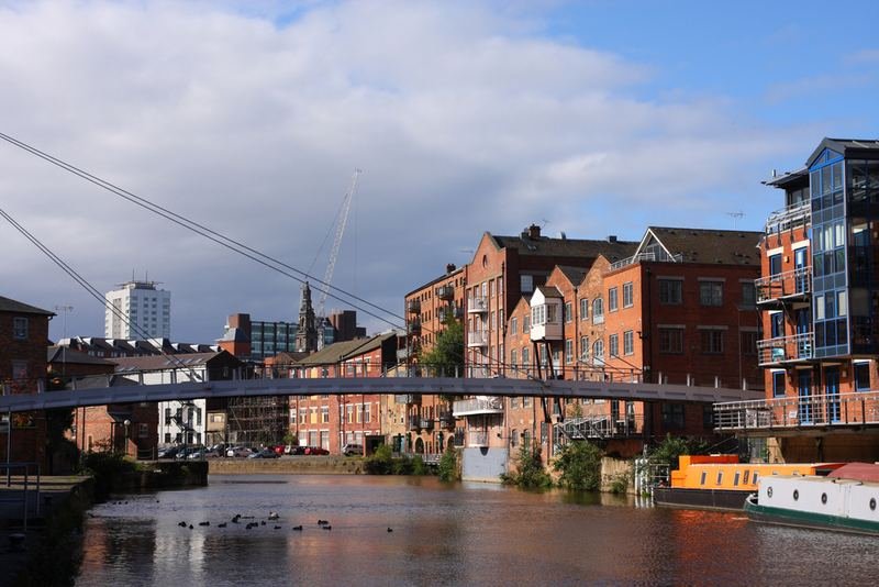 Converted warehouses and a footbridge on the River Aire in Leeds
