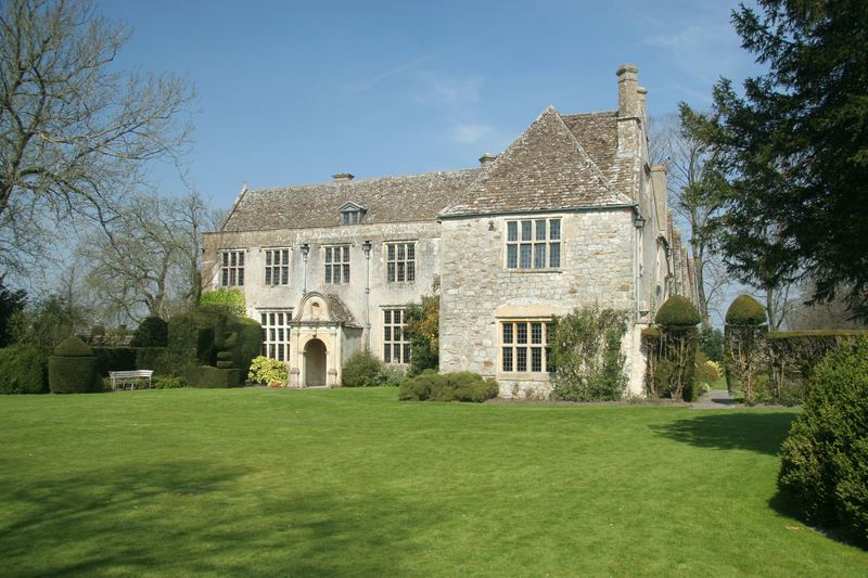 A stone manor house across a wide lawn