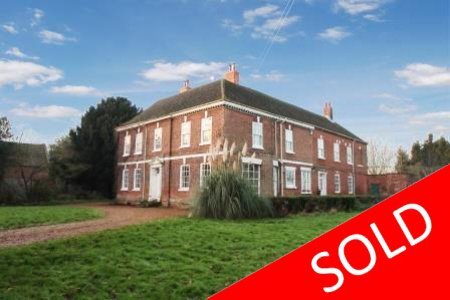 Historic Grade II listed country house with land and outbuildings.