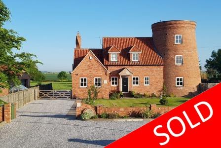 Quirky windmill style new build with land and rural views.